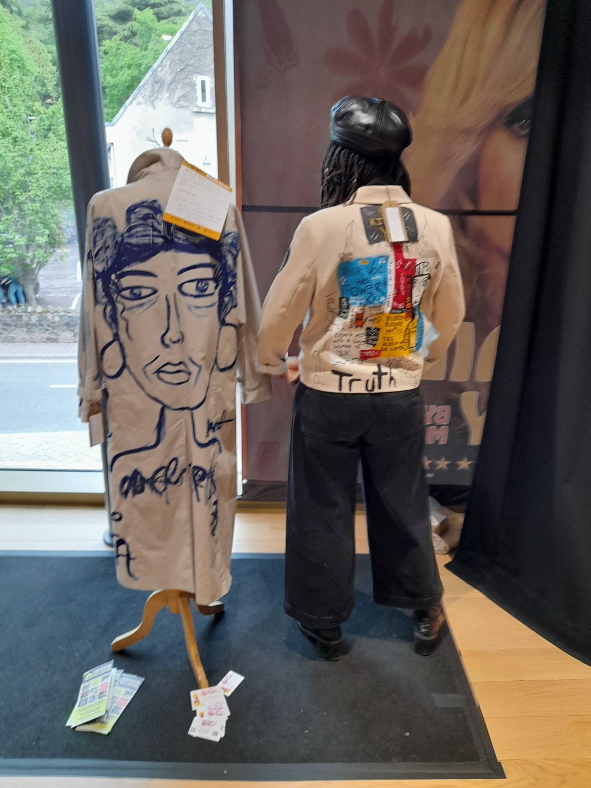 Painted garments and wearable artwork by ENNÈ displayed on mannequins