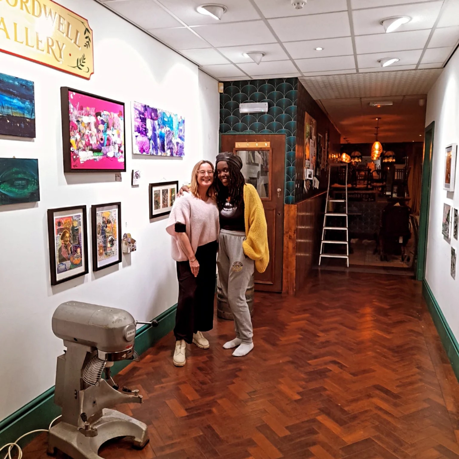 ENNÈ in a gallery with exhibited artworks