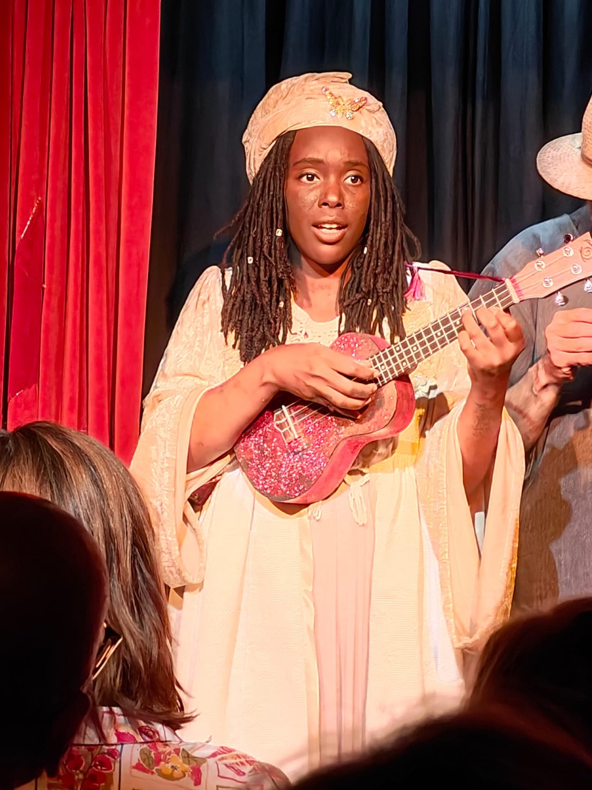 ENNÈ performing with a pink ukulele in costume